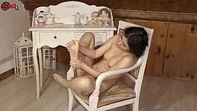 Brunette babe puts oil on her sexy feet in dollscult video