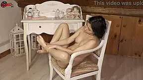 Brunette babe puts oil on her sexy feet in dollscult video