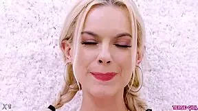 radiant blonde girl poses in photoshoot on sofa