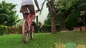 Is Tobie, the horny teen slut, rubbing and fingering herself in the garden?