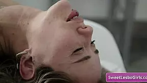 Horny blonde lesbians kiss and lick on massage table