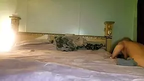 The ant crawls barefoot through the wet grass near the cowgirl's feet with natural features.