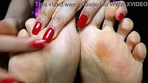 Small feet mistress with red toenail polish dominates sensually, sweat glistening