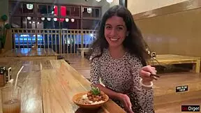 a girl eats sushi rolls in a bar