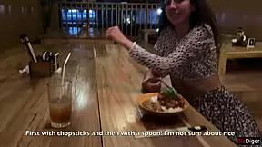 a girl eats sushi rolls in a bar