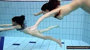 Shaved brunette with big tits underwater?