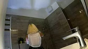 Beautiful hot cheerleader in see-through top and mini skirt flashes panties in bathroom.