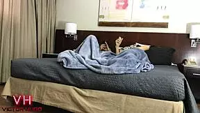 Couple relaxes in a hotel room.