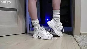 Delicate legs in sneakers are waiting for you
