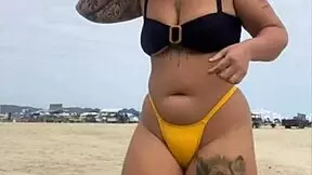 young african girl wears tight yellow bikini splitting swollen pussy to attract attention on usa beach