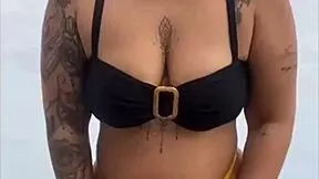 young african girl wears tight yellow bikini splitting swollen pussy to attract attention on usa beach