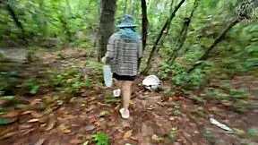 thai girl walks and talks while picking mushrooms in the deep forest