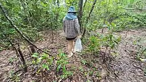 thai girl walks and talks while picking mushrooms in the deep forest