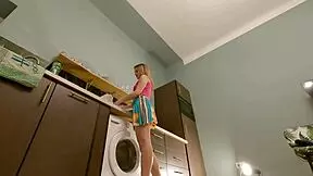 Is the hot brunette babe taking off her panties in the kitchen?