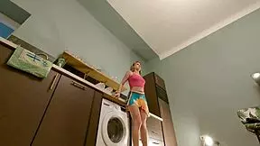 Is the hot brunette babe taking off her panties in the kitchen?