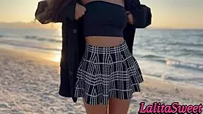 Latina beauty teases on the beach and shows off her tight body