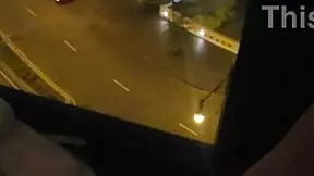 woman relaxing in public near hotel window
