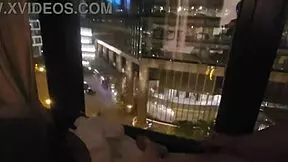 woman relaxing in public near hotel window