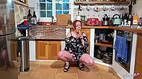 Watch this German redhead get fucked in the kitchen with a banana.