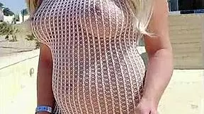 Blonde exhibitionist flashes big tits and ass in transparent dress outdoors without underwear