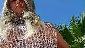 Blonde exhibitionist flashes big tits and ass in transparent dress outdoors without underwear