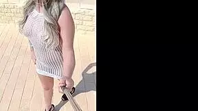 Blonde exhibitionist flashes big tits and ass in transparent dress outdoors without underwear