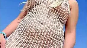 Blonde exhibitionist flashes big tits and ass in transparent dress outdoors without underwear