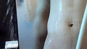 muscular handsome guy enjoys his shower time