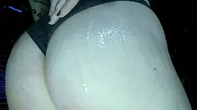 young european woman gets a big butt oil massage with colourful glitters