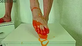 Pretty blonde Alice Klay teases with orange slime on bare feet!