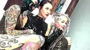 Behind the scenes of a latex domination shoot with fingering and licking