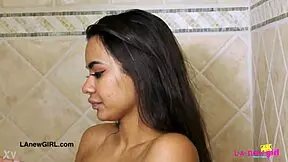 Bronze-skin model enjoys a relaxing shower.