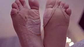 Sexy blonde displays her feet in nylons and leggings, inviting foot fetish fun