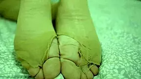 Sexy blonde displays her feet in nylons and leggings, inviting foot fetish fun