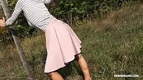 Granny deepthroats young cock on grass. Want to see her bent over?