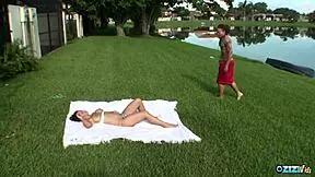 When he notices a topless busty brunette sunbathing. He gets his big cock out immediately