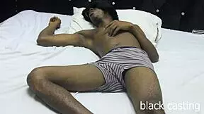 african lovers relaxing on bed