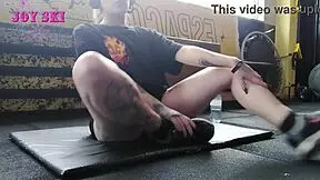 alternative girl stretching at the gym