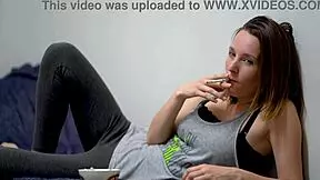 Brunette Babe with Blue Eyes Teases While Smoking in Voyeur Scene