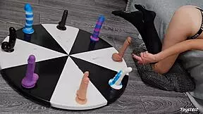she spins the wheel of dildos to win her orgasm