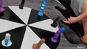 she spins the wheel of dildos to win her orgasm