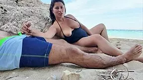 This horny curvy stepmom flashes her big tits on the public beach.