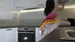 Redhead cheerleader shows panties in kitchen