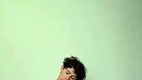 Horny young girl masturbating with big cock on bed.