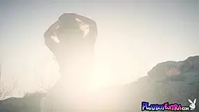 As the sun sets, petite blonde hottie Emma Hix poses nude outdoors.