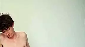 Horny young girl masturbating with big cock on bed.