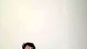 Horny young girl masturbating with big cock on bed.