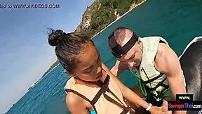 Asian girlfriend sucks cock hard on public jetski