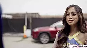 One asian cheerleader licks shaved classmate cunt on classroom desk casually