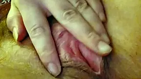 woman moans softly while rubbing clit with vibrator and fingers gently